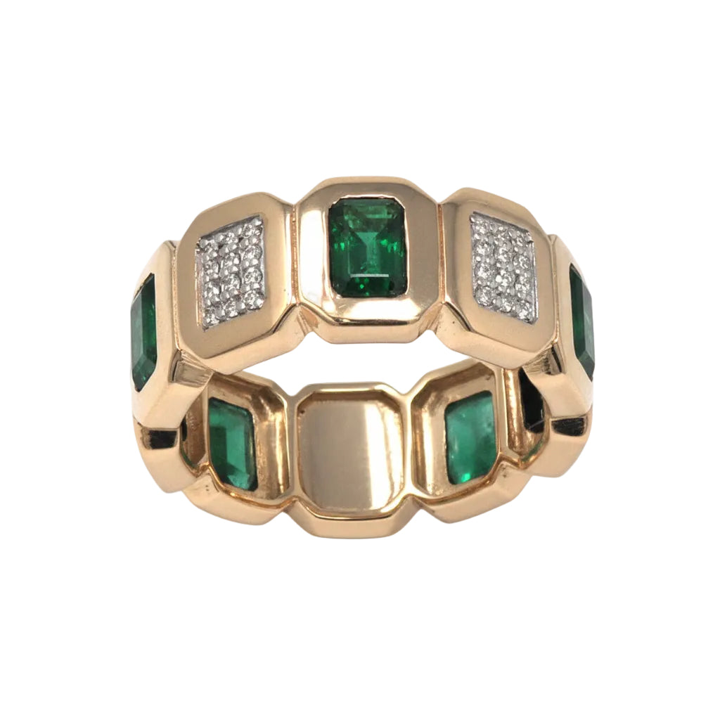 Gold ring with emerald green gemstones on a white background