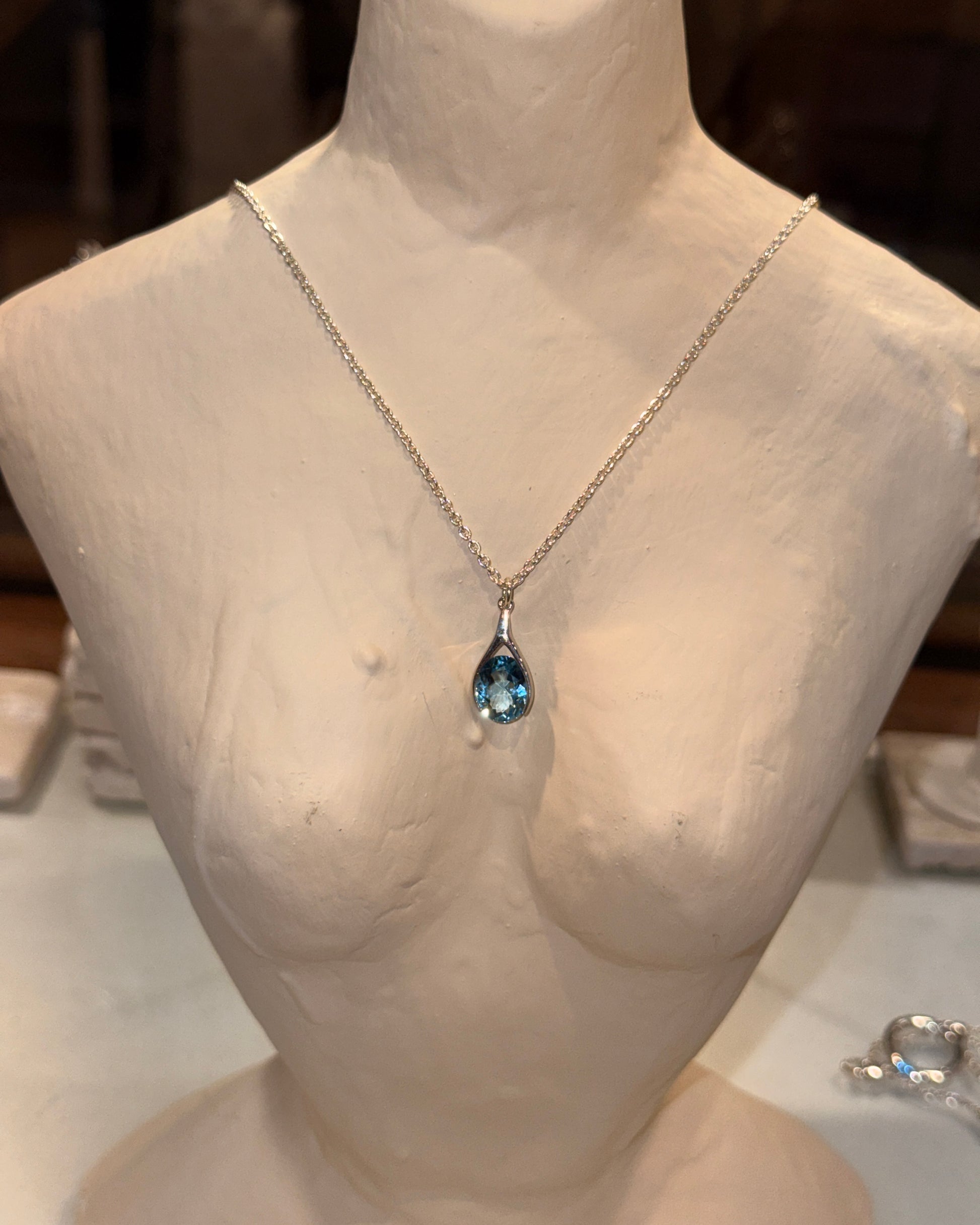Versani NY Women's Teardrop Pendant in Sterling Silver with a Pear-Cut Blue Topaz gemstone.