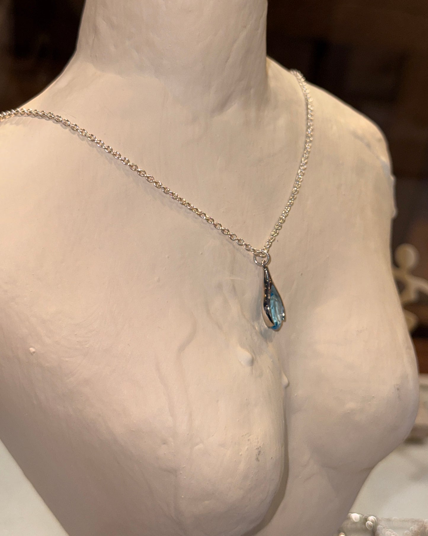 Versani NY Women's Teardrop Pendant in Sterling Silver with a Pear-Cut Blue Topaz gemstone.