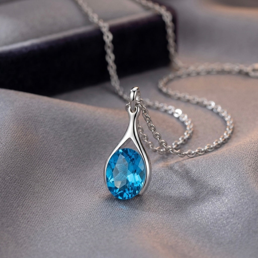 Versani NY Women's Teardrop Pendant in Sterling Silver with a Pear-Cut Blue Topaz gemstone.