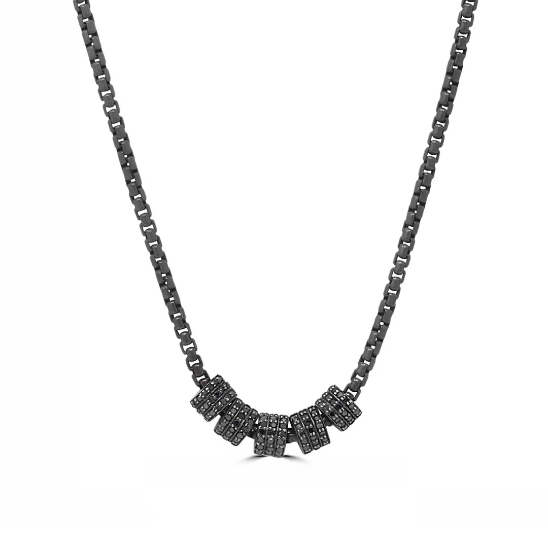 Black diamond cylinders necklace on a white background