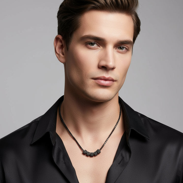 Black diamond cylinders necklace on a white background