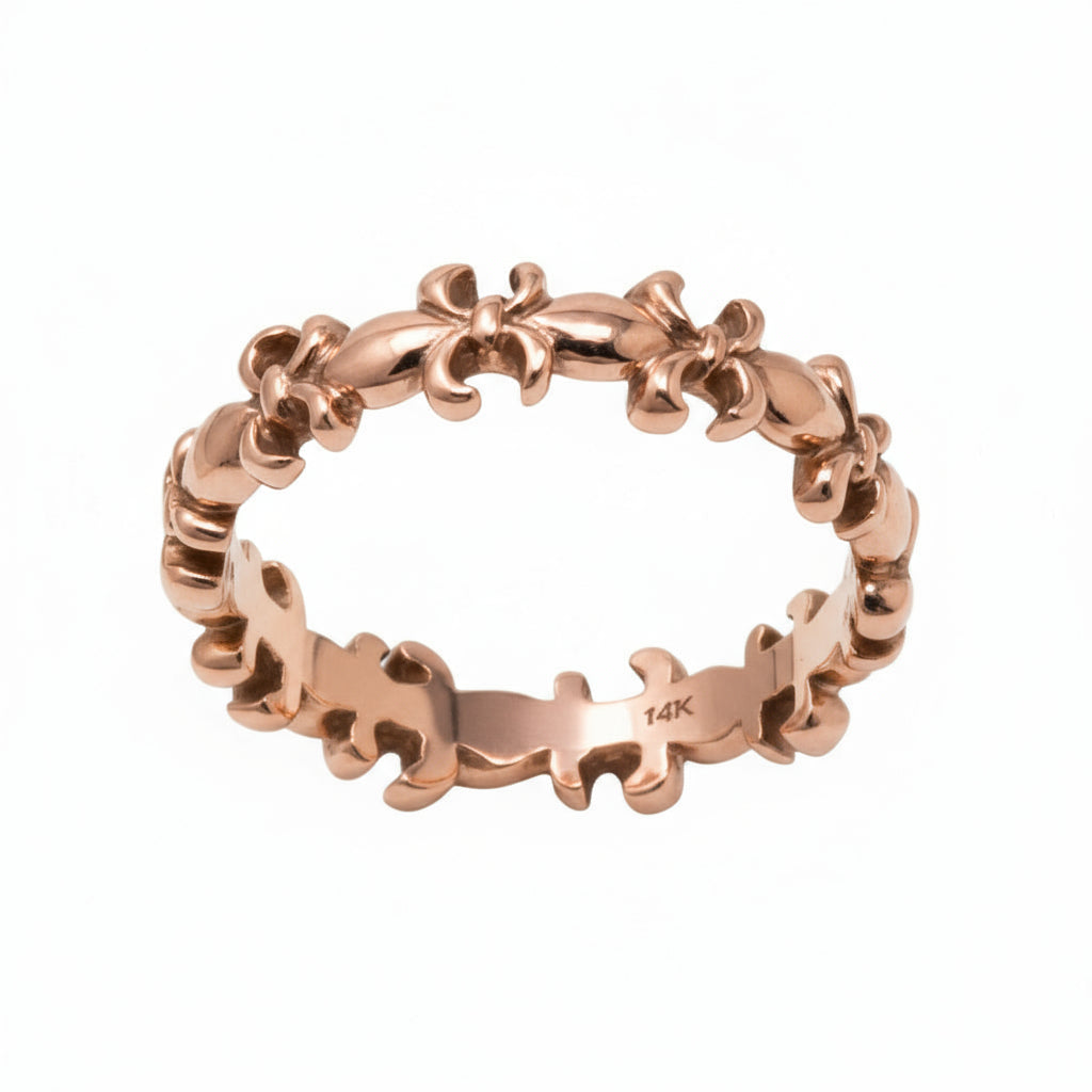 fleur de lis Gold ring with intricate design on a white background