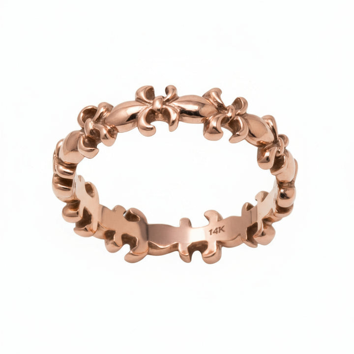 fleur de lis Gold ring with intricate design on a white background