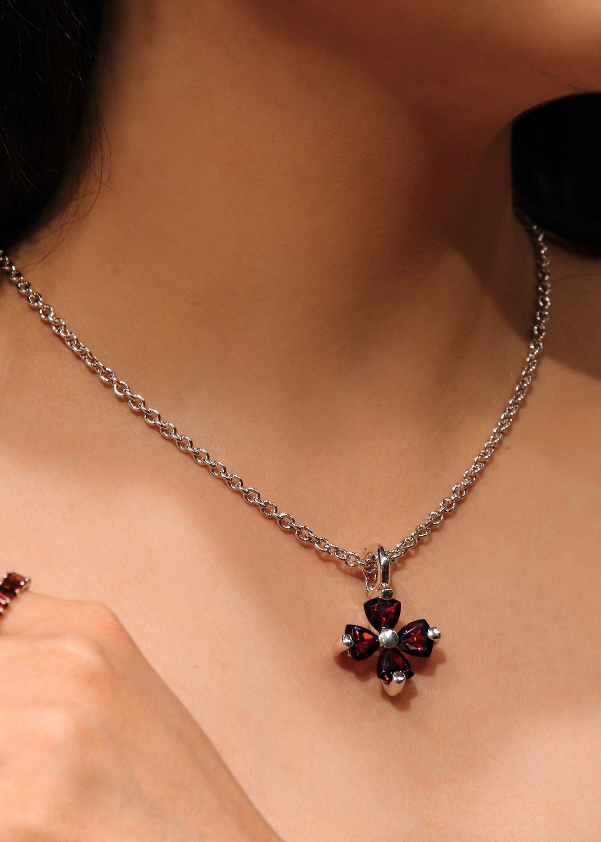 Versani Soho Women's Gemstone Tension Statement Flower Pendant in Sterling Silver with Blue Topaz and Garnet gand Aquamarine 
emstones.