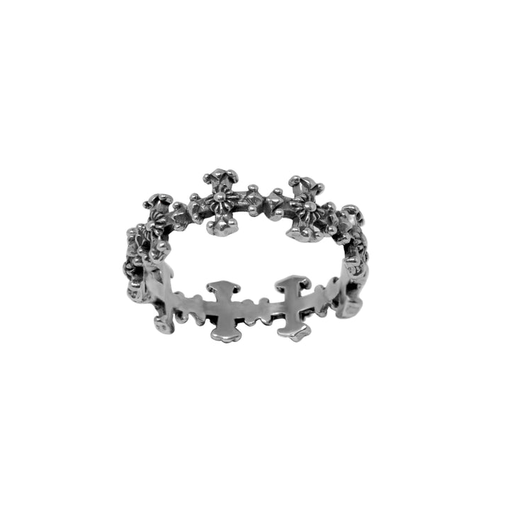 Silver ring with linked crosses on a white background