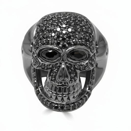 A men's ring featuring a black diamond skull design with a polished finish.