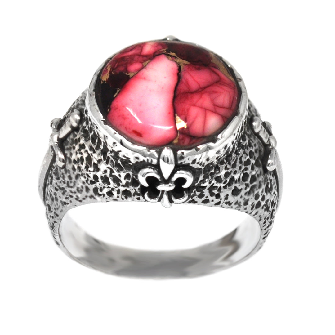 Silver ring with a red gemstone and fleur-de-lis design on a white background
