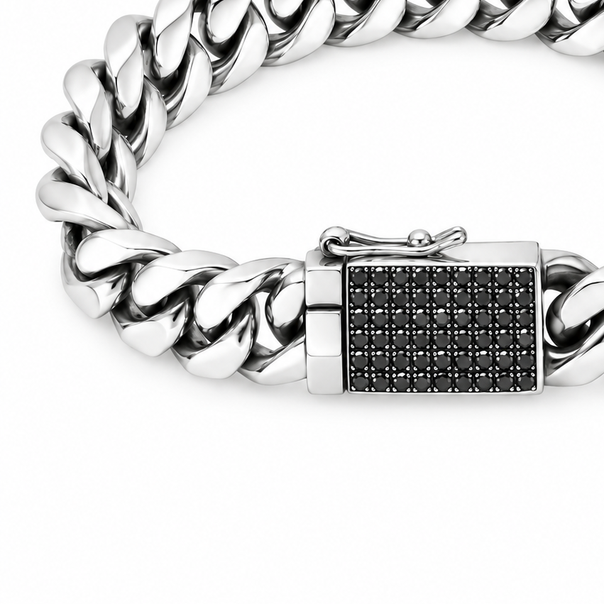 Sterling silver Cuban link chain bracelet with a rectangular clasp paved with small black diamonds.