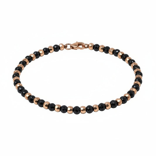 A bracelet with black diamond beads and rose gold accents